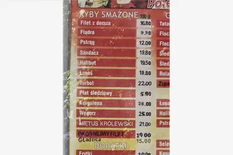 Cennik ryb smażonych: dorsz 16.80, flądra 9.90, pstrąg 12.00, sandacz 19.80, halibut 19.50, łosoś 19.80, turbot 22.00, płat śledziowy 5.90.