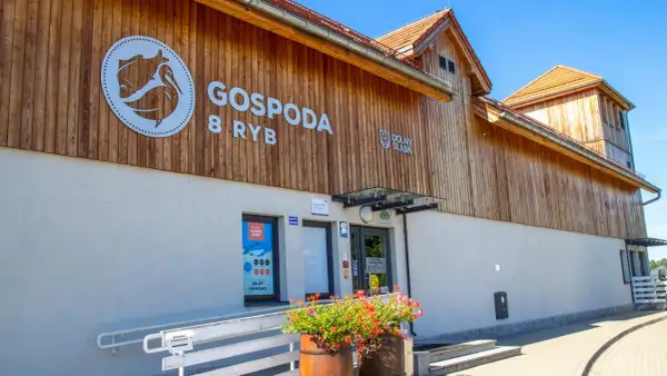 Gospodą 8 Ryb w Miliczu, smażalnia ryb z drewnianą elewacją i logo z rybą.